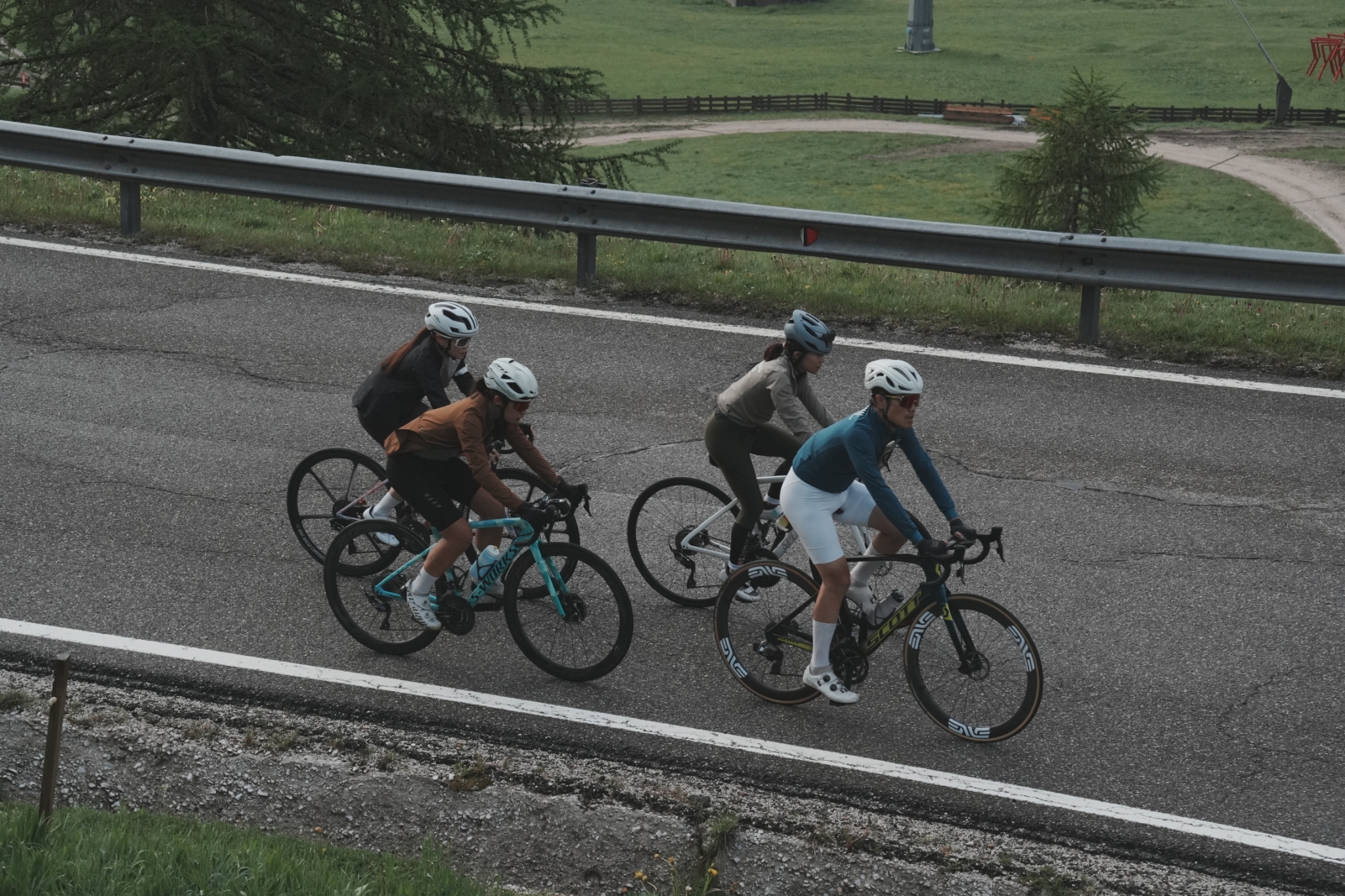 Cyclists rounding a high mountain hairpin