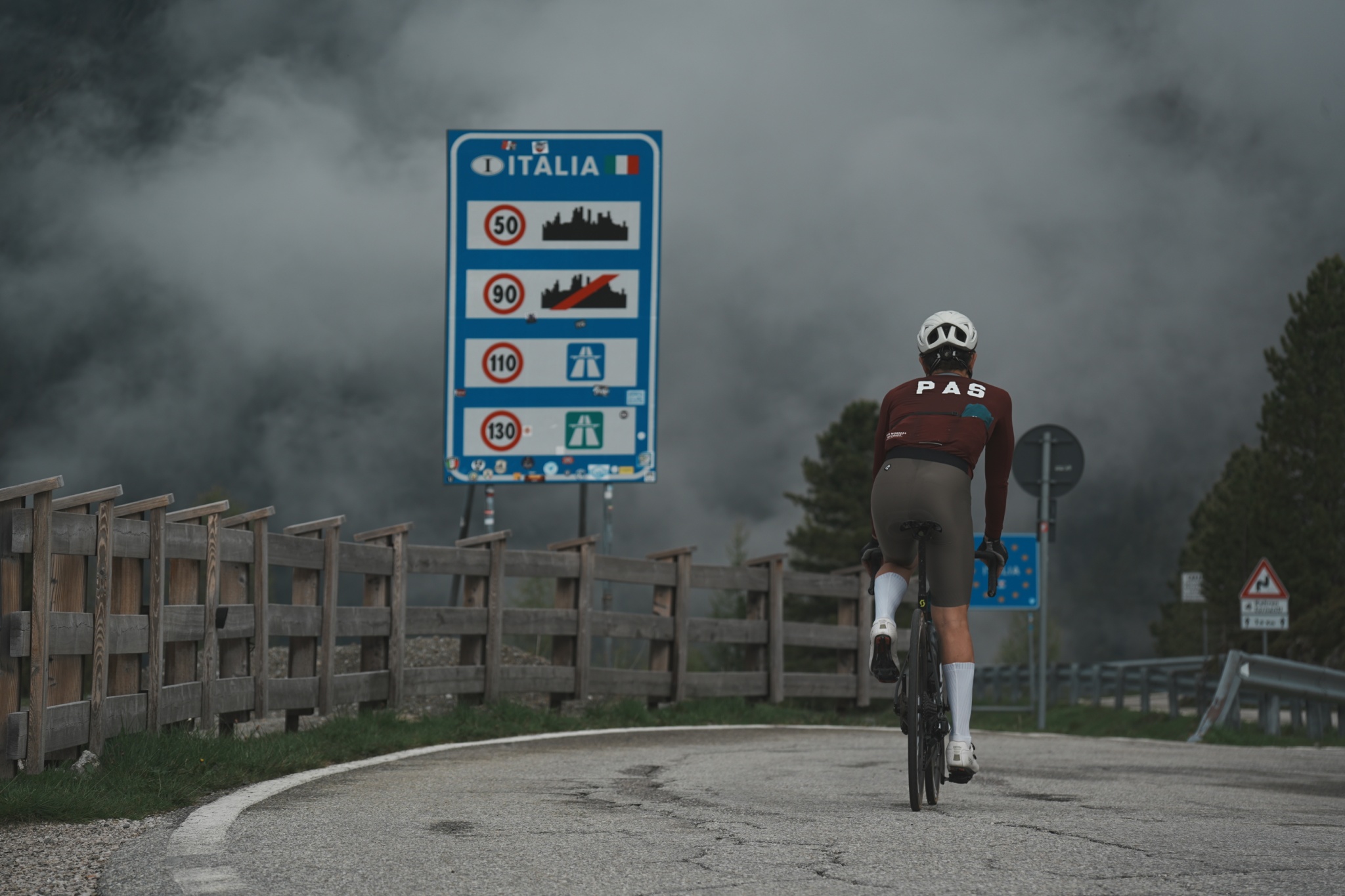 A cyclist on a cross-border Alpine road