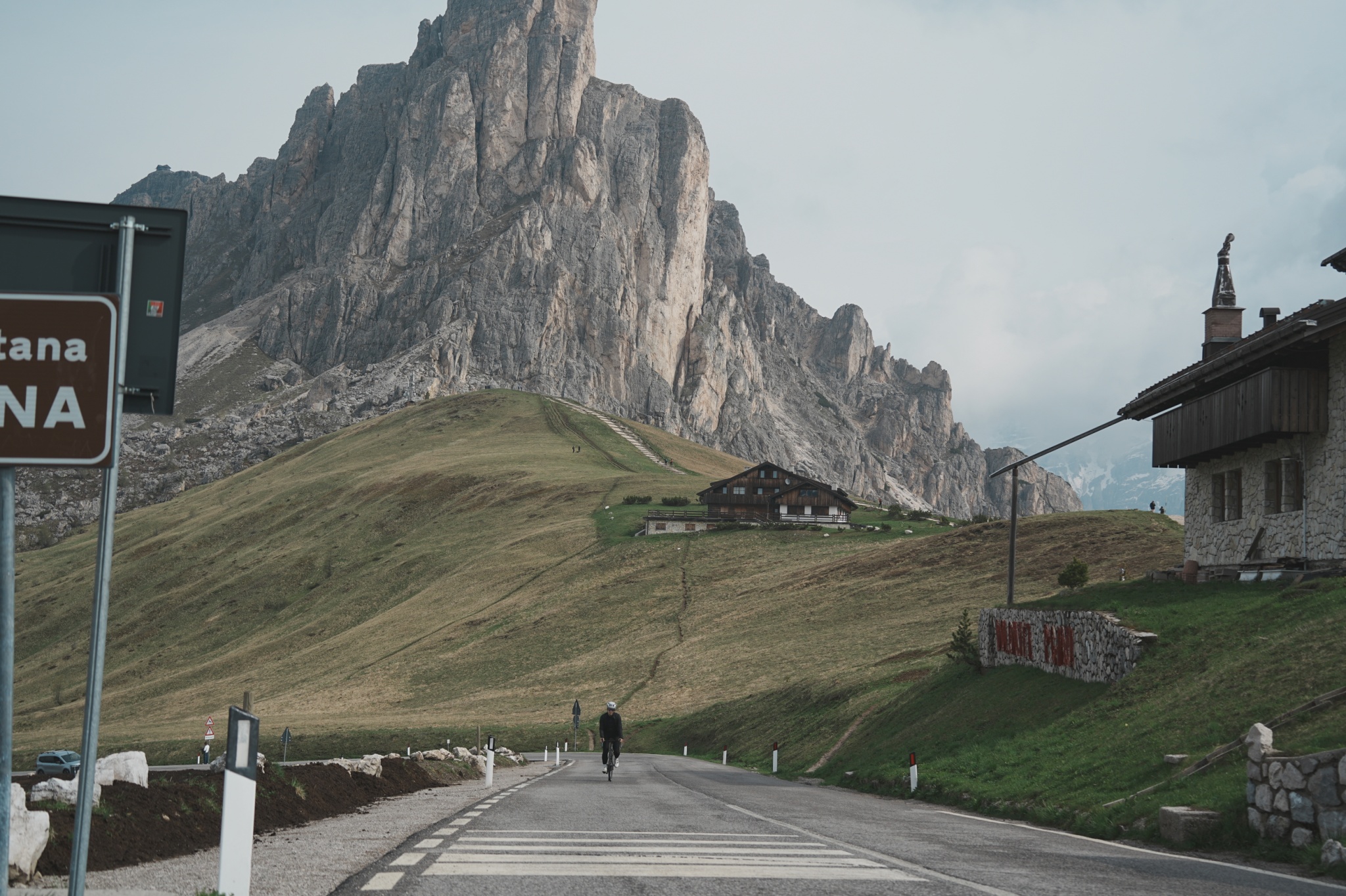 An open road winding through green mountain terrain