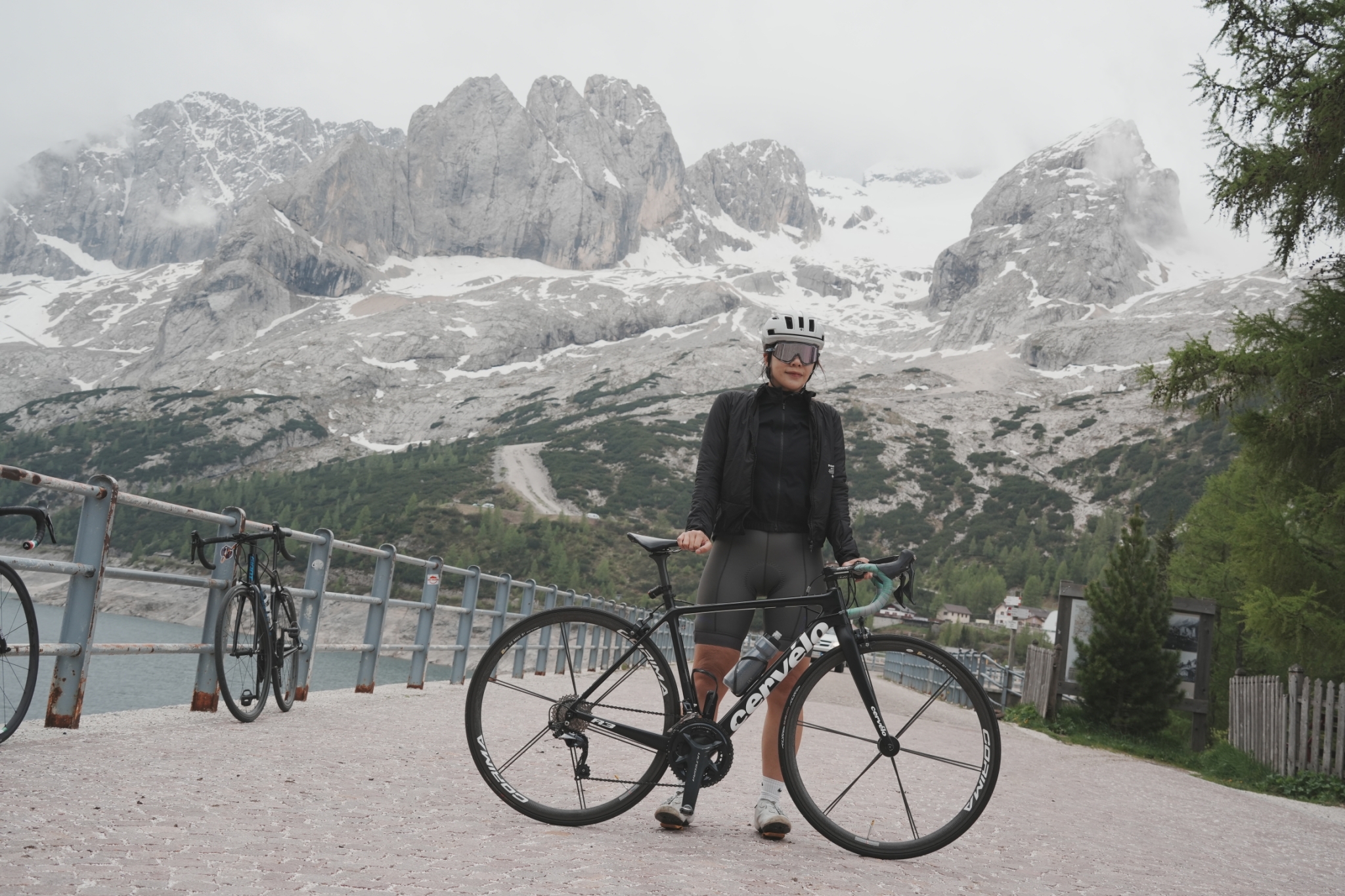 Cyclist with a bike beneath high Dolomite peaks