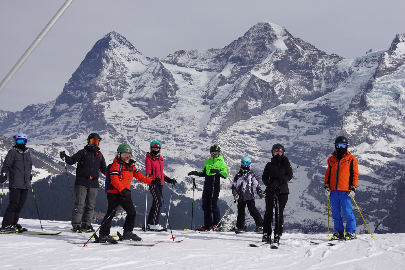 Friends skiing beneath the Bernese Alps
