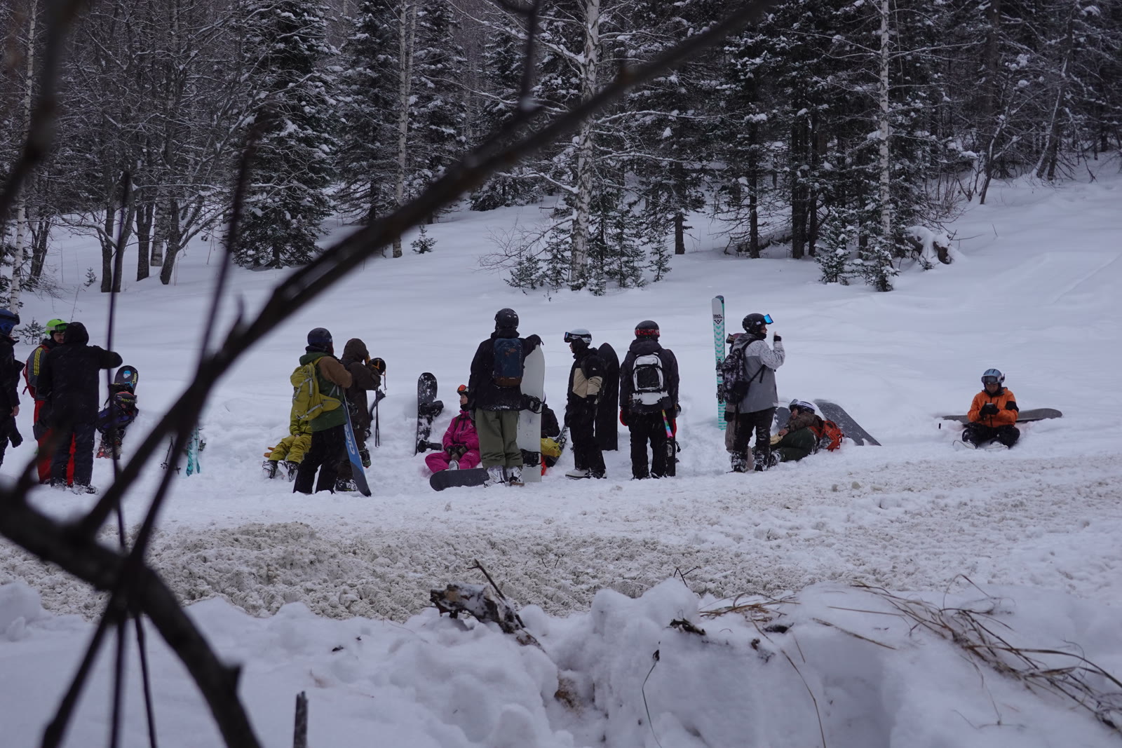 The group taking a break together in the snowy forest.