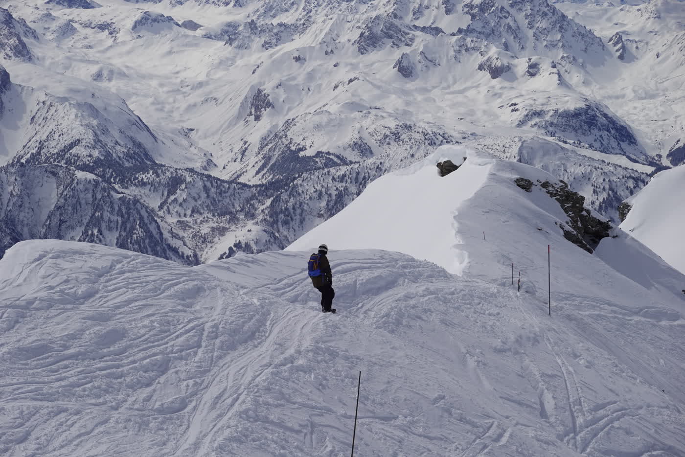 Skier crossing a high ridge in La Plagne