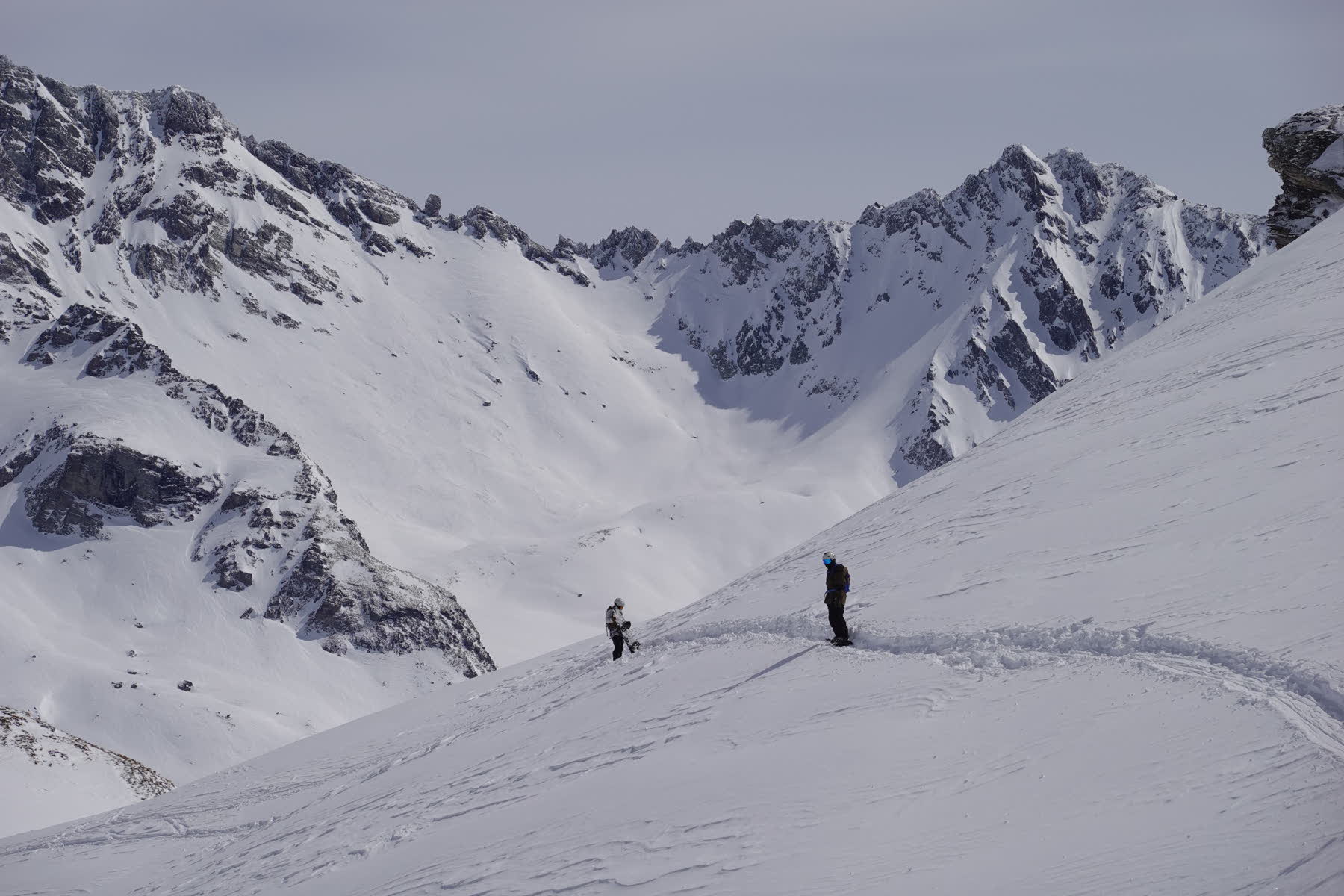 Skiers on a snowy ridge above La Plagne