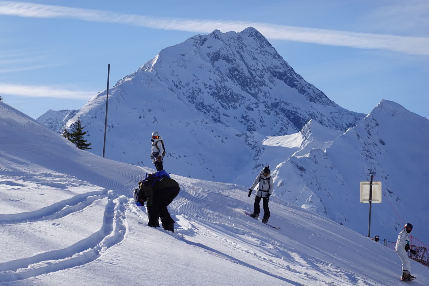 Skiers on a broad La Plagne piste