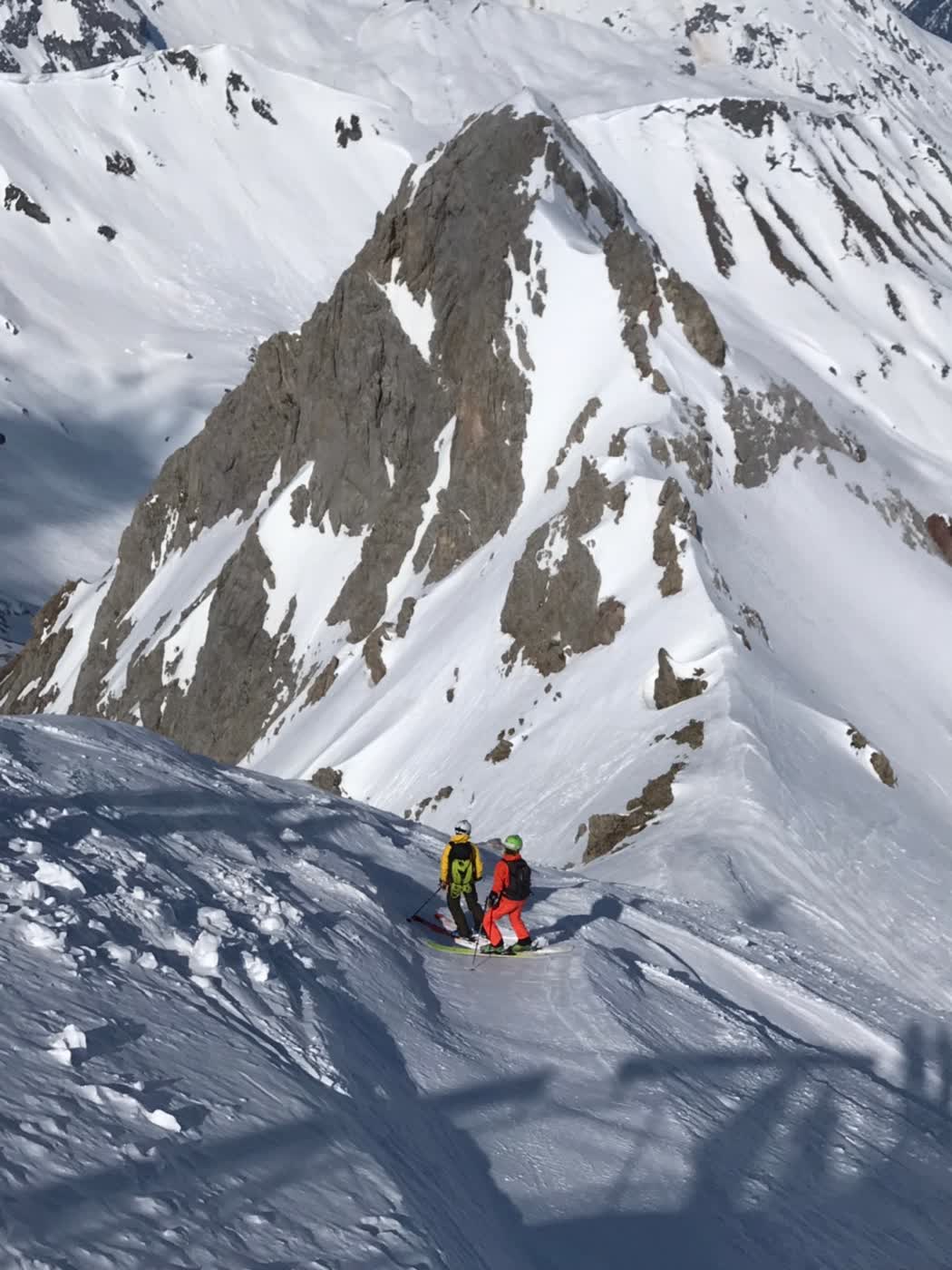 Skiers on a snowy ridge in St. Anton