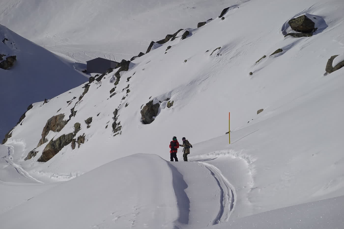 Skiers on a snow ridge near St. Moritz
